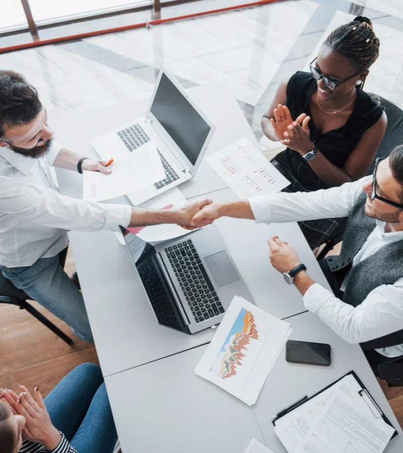 young-employees-sitting-office-table-using-laptop-team-work-brainstorming-meeting-concept
